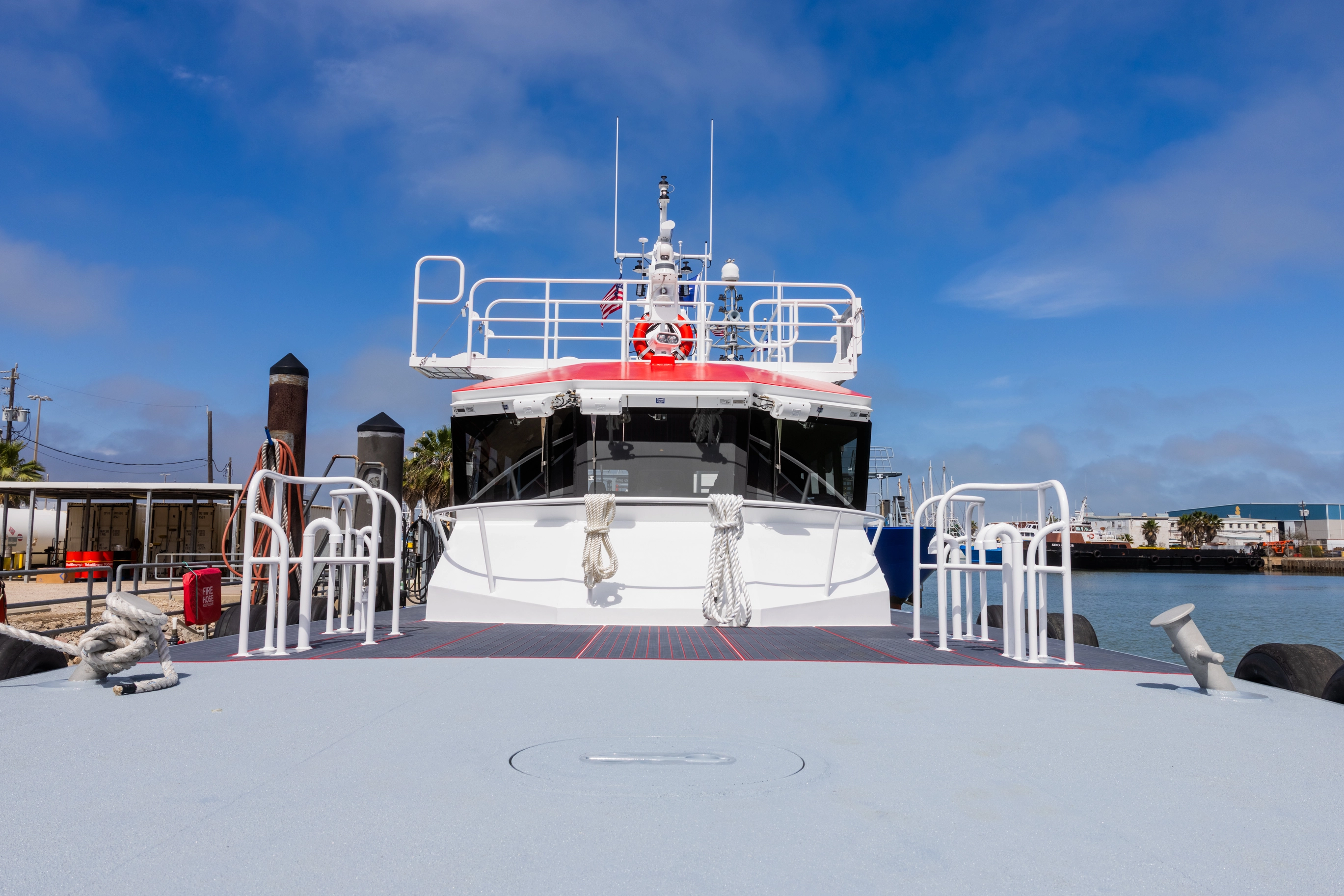 Cargo ship with tugboats in a working harbor — Breaux's Bay Craft vessel inquiries